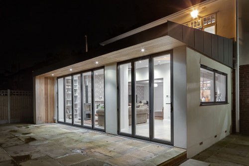 Priest C Shenfield Contemporary Extension bifold doors open plan family area fireplace garden patio night view