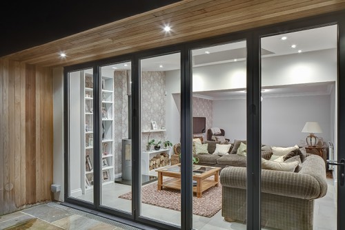 Priest C Shenfield Contemporary Extension bifold doors open plan family area fireplace night view