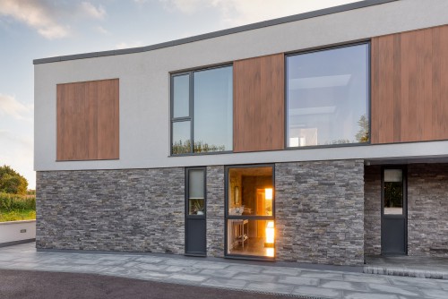 North Tye Swanley New Build Contemporary Home corner front view grey stone cladding timber cladding white render side view