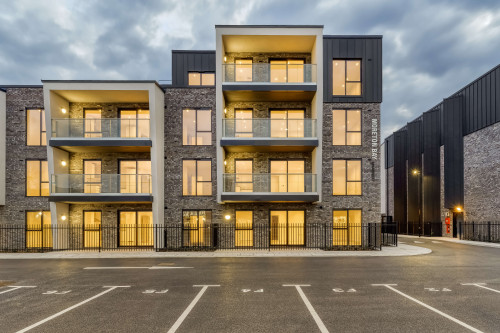 Moreton bay apartments romford open plan living sustainability eco friendly award winning modern nightlights carpark saw tooth windows metal signs