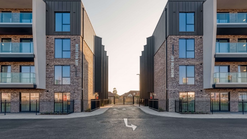 Moreton bay apartments romford open plan living sustainability eco friendly award winning modern car park driveway view dusk saw tooth windows balcony windows zink contemporary architectecture v2